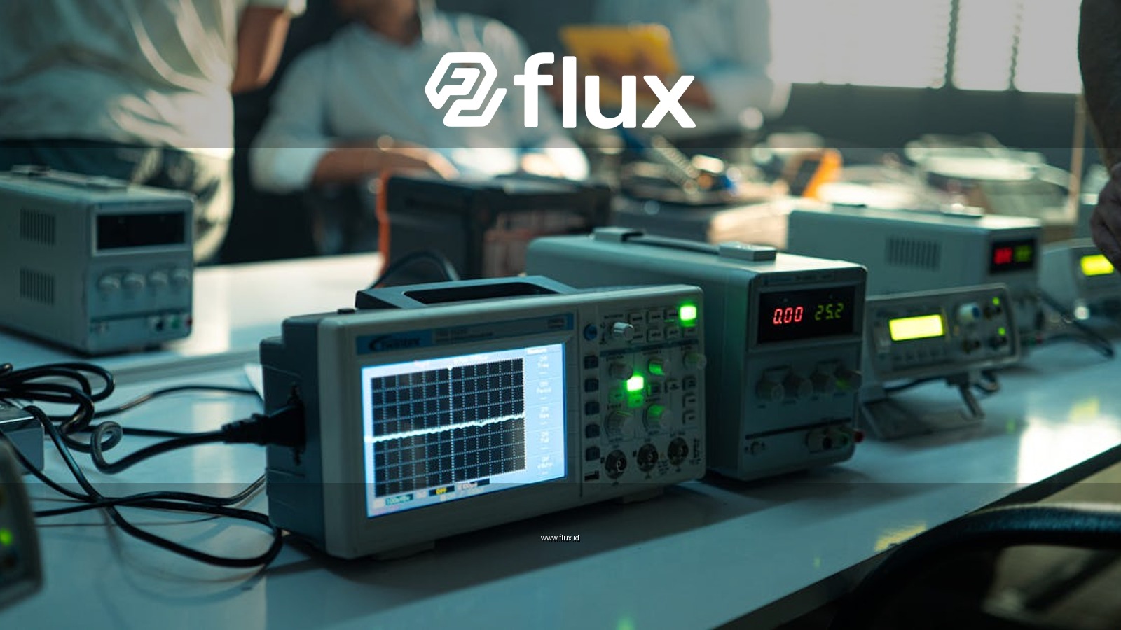 Engineers working in an electronics lab with oscilloscopes and other equipment on a bright day.