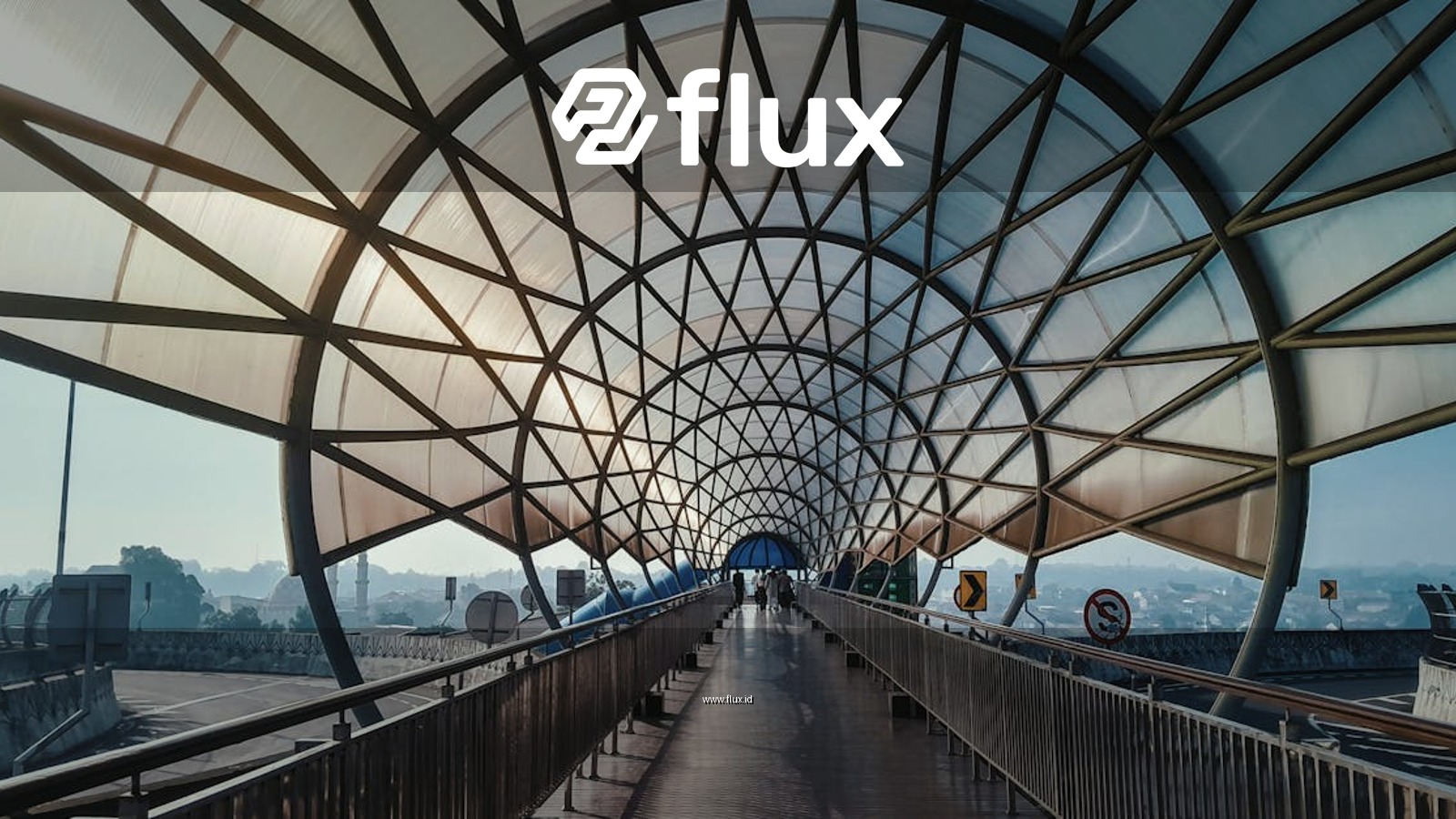 A stunning pedestrian bridge with a modern architectural roof structure featuring geometric patterns under the morning sun.