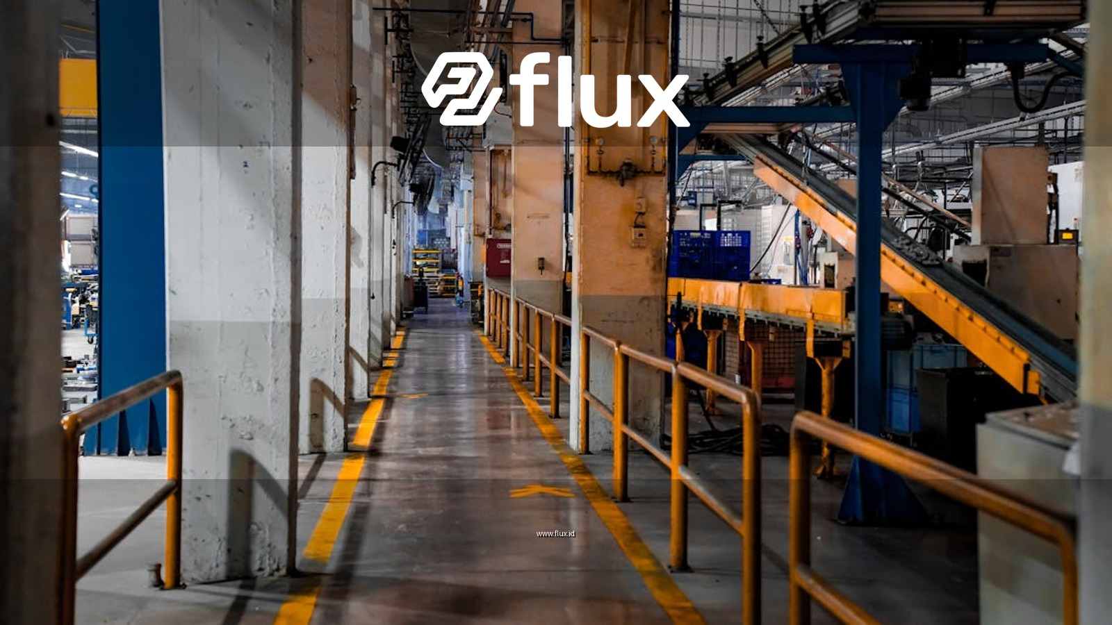 Wide view of a modern factory interior showcasing industrial machinery and conveyor systems.
