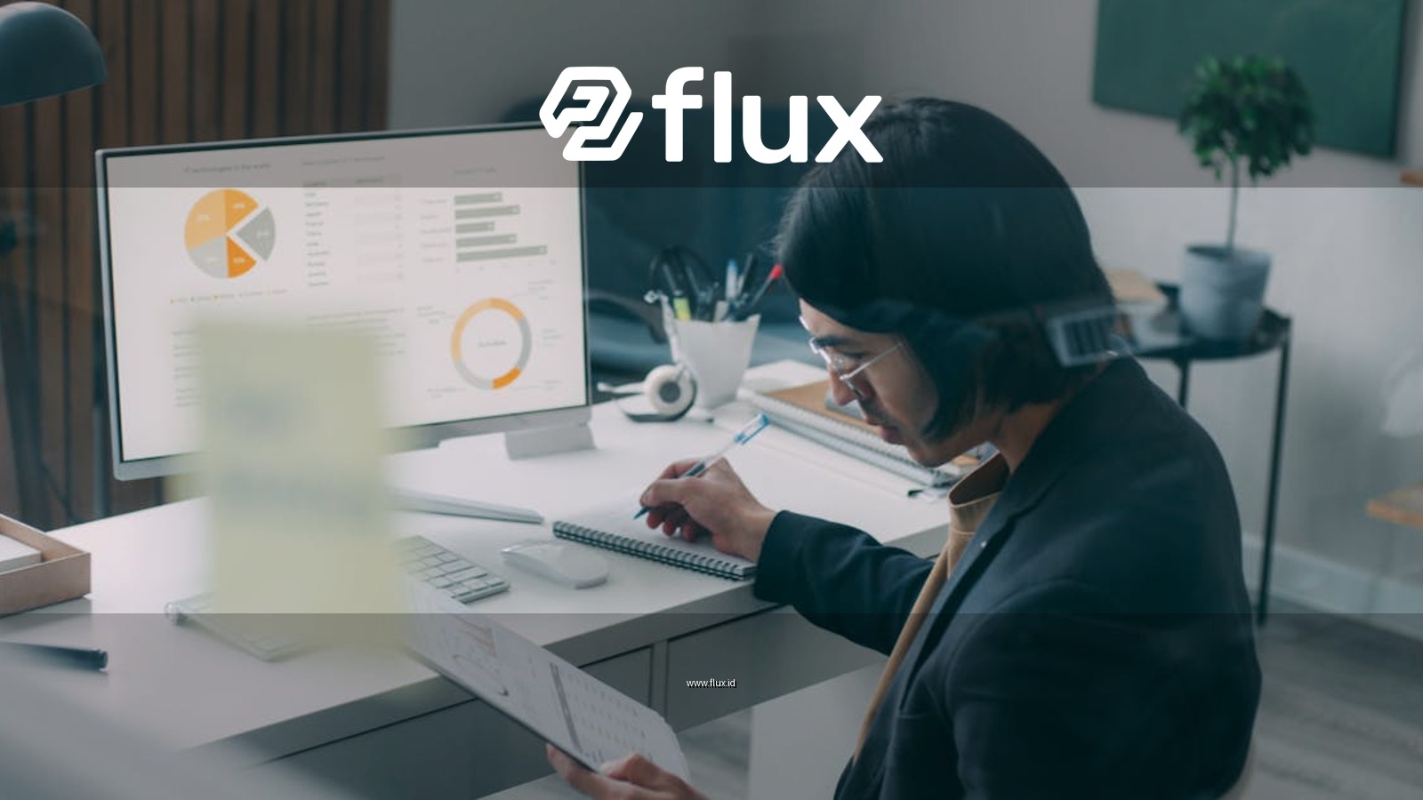 Business person reviewing analytics and charts at a modern office desk.