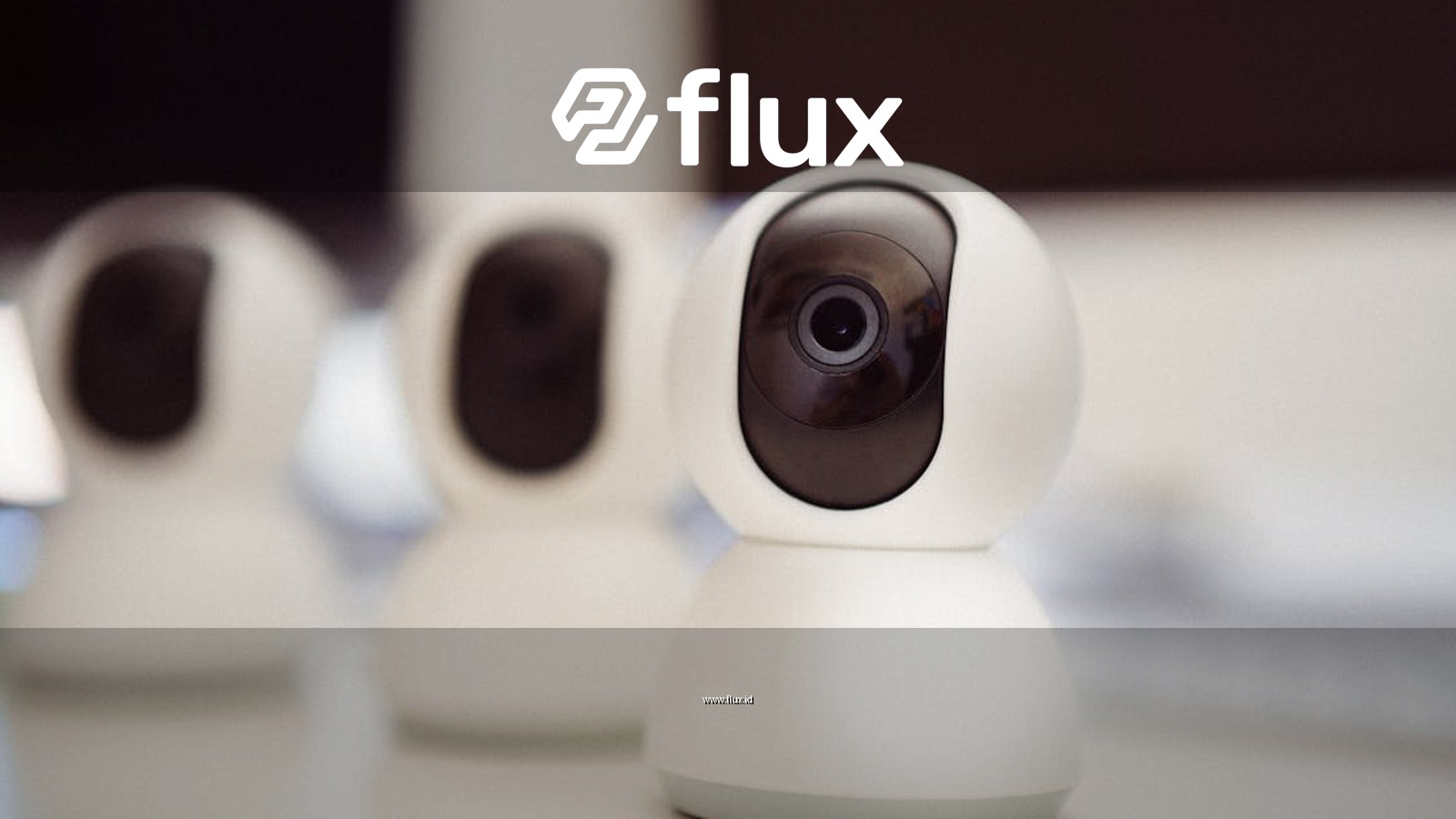 Close-up of three smart home security cameras placed on a white desk indoors.