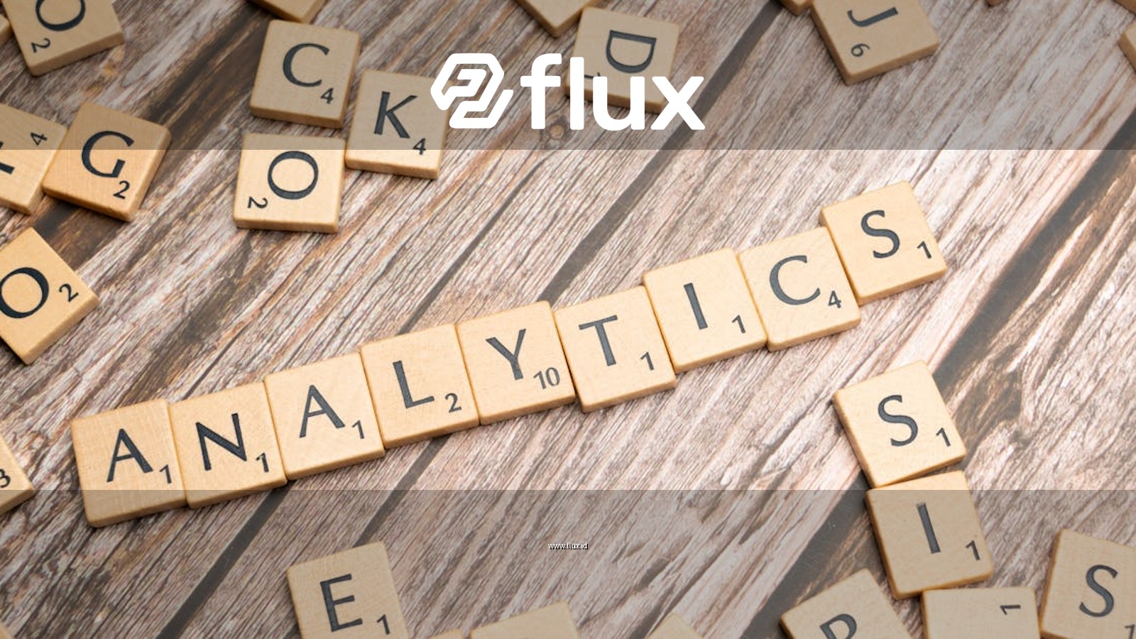 Scrabble tiles spelling 'Analytics' on a wooden surface, symbolizing data analytics concept.