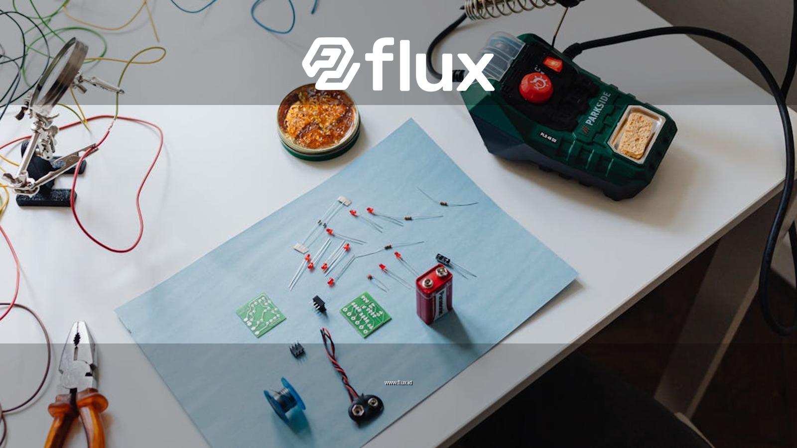 A workspace with a soldering station, tools, and electronic components ready for repair.