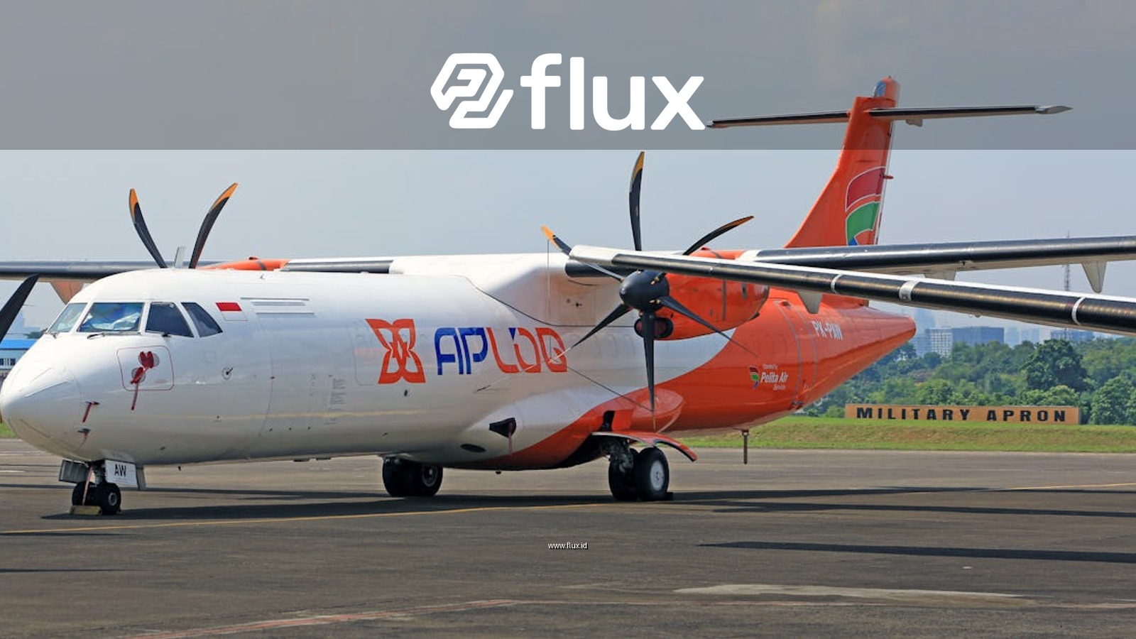 Front view of a commercial propeller aircraft at an Indonesian airport.