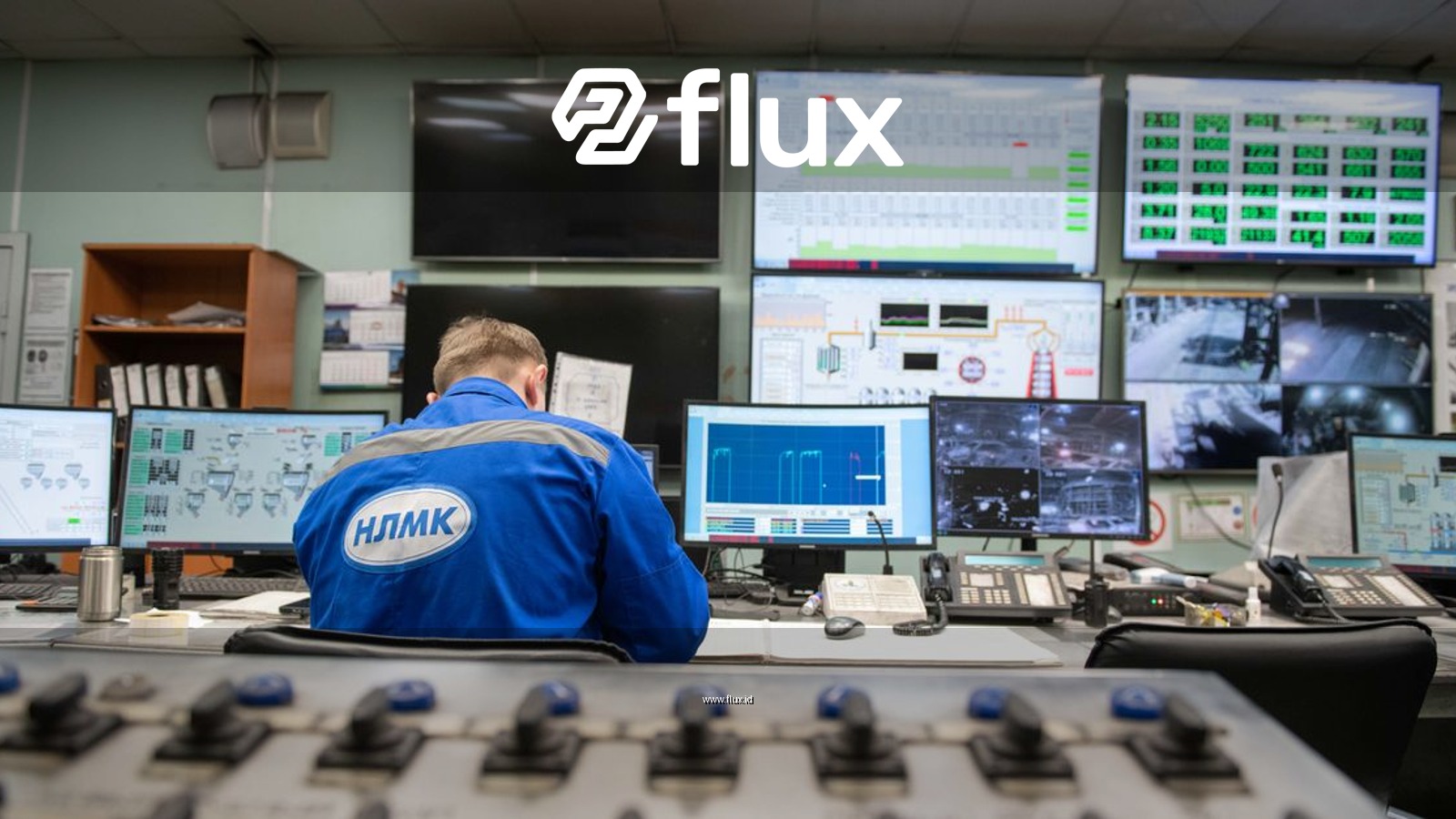 An engineer monitors multiple screens in an industrial control room, ensuring smooth operations.