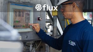 Engineer using control panel at industrial facility, ensuring operational efficiency.