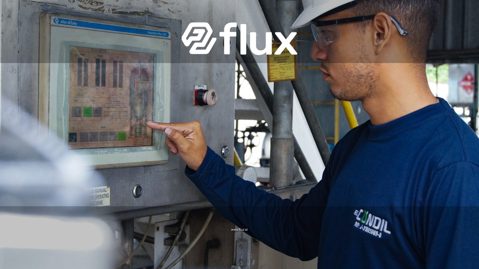 Engineer using control panel at industrial facility, ensuring operational efficiency.