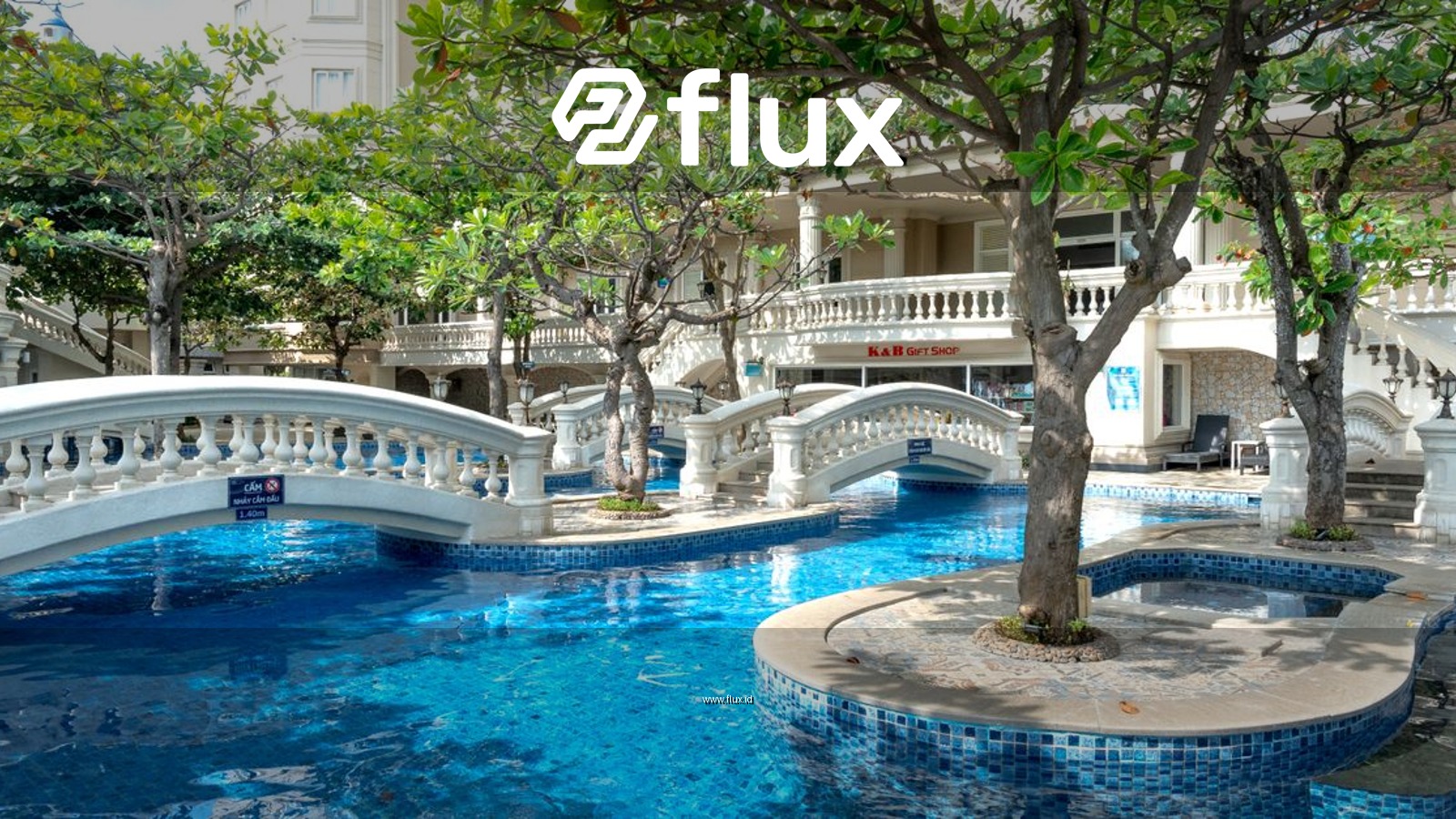 A luxurious swimming pool surrounded by arch bridges and lush trees, ideal for relaxation.