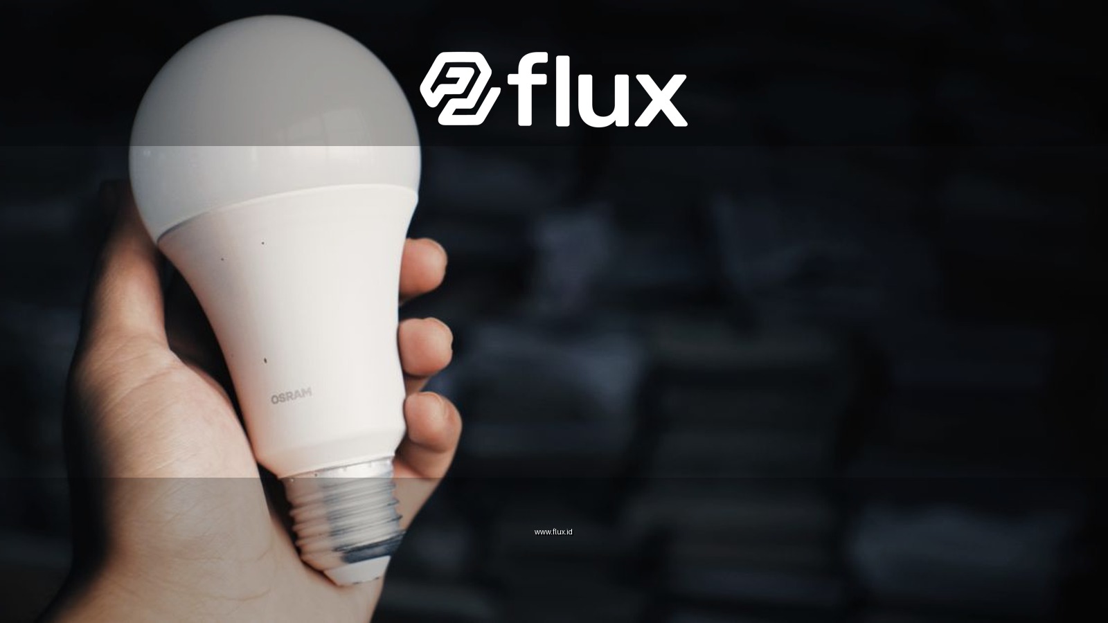 Crop anonymous person showing light bulb in hand against heap of books in dark room