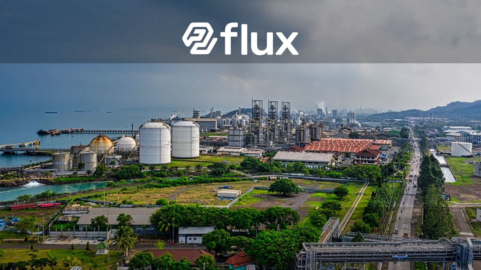 Aerial view of a coastal industrial area in Banten, Indonesia, with factories and overcast skies.