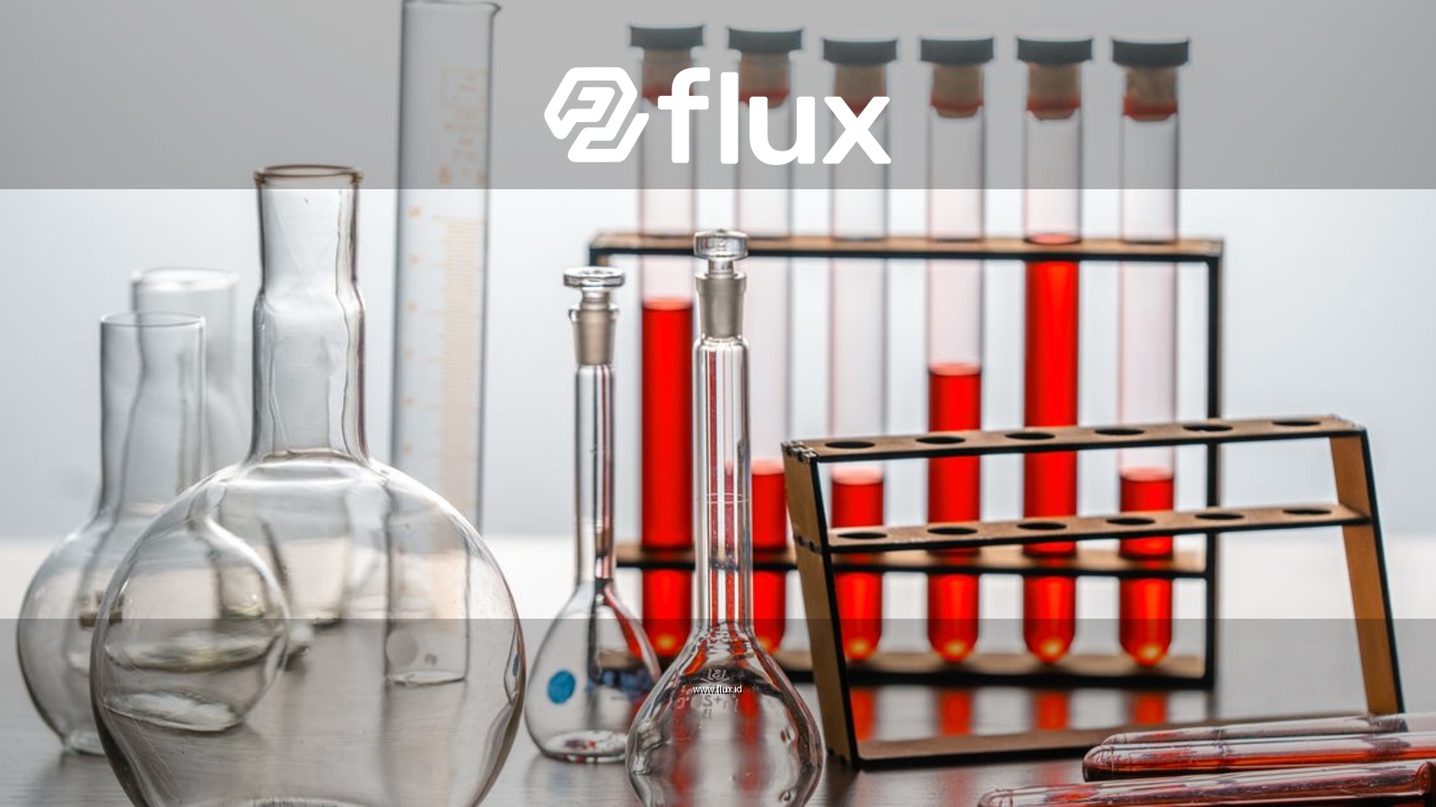 Close-up of various lab glassware with red liquids, ideal for scientific or educational use.