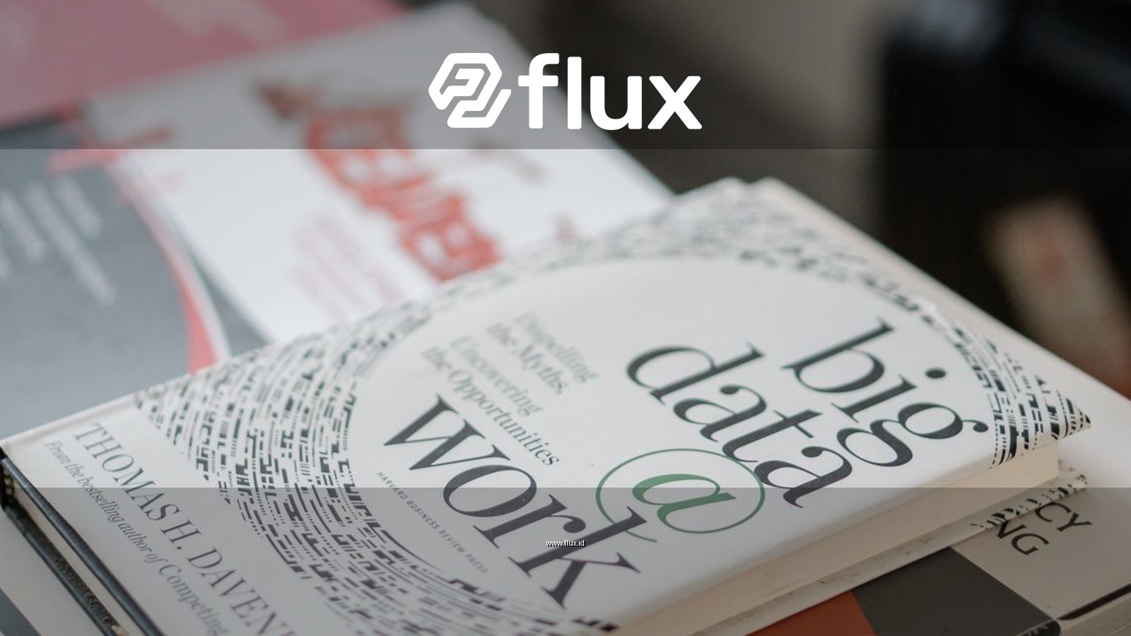 Close-up of books on data analytics and business strategies on a desk.