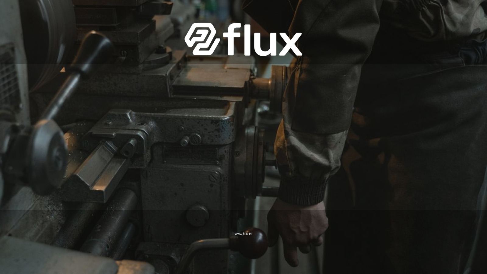 Close-up of a craftsman working on a lathe machine in an indoor workshop setting.