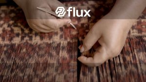 Close-up of hands weaving traditional Gringsing fabric in Tenganan, Bali, Indonesia.