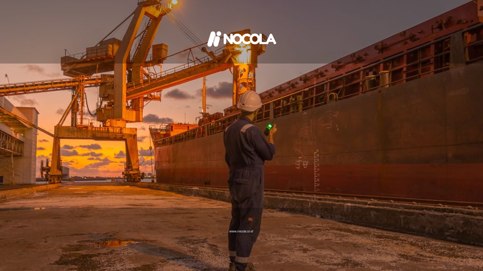 A dock worker examines a cargo ship under twilight skies at a Libyan port, highlighting industrial operations.