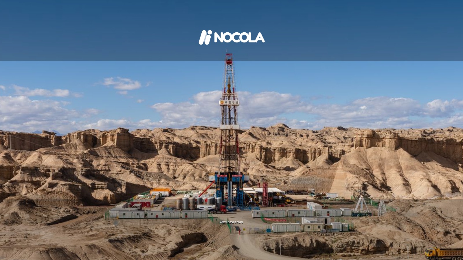 Aerial view of an oil rig amidst desert rock formations, showcasing industrial exploration.
