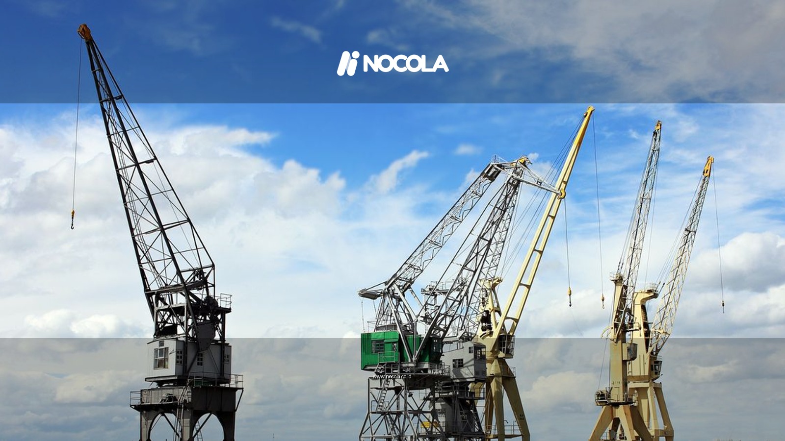 Industrial cranes reaching into a bright blue sky with scattered clouds, a symbol of construction and industry.