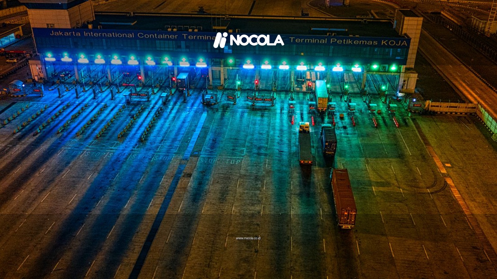 Illuminated aerial view of Jakarta International Container Terminal highlighting logistics activity at night.