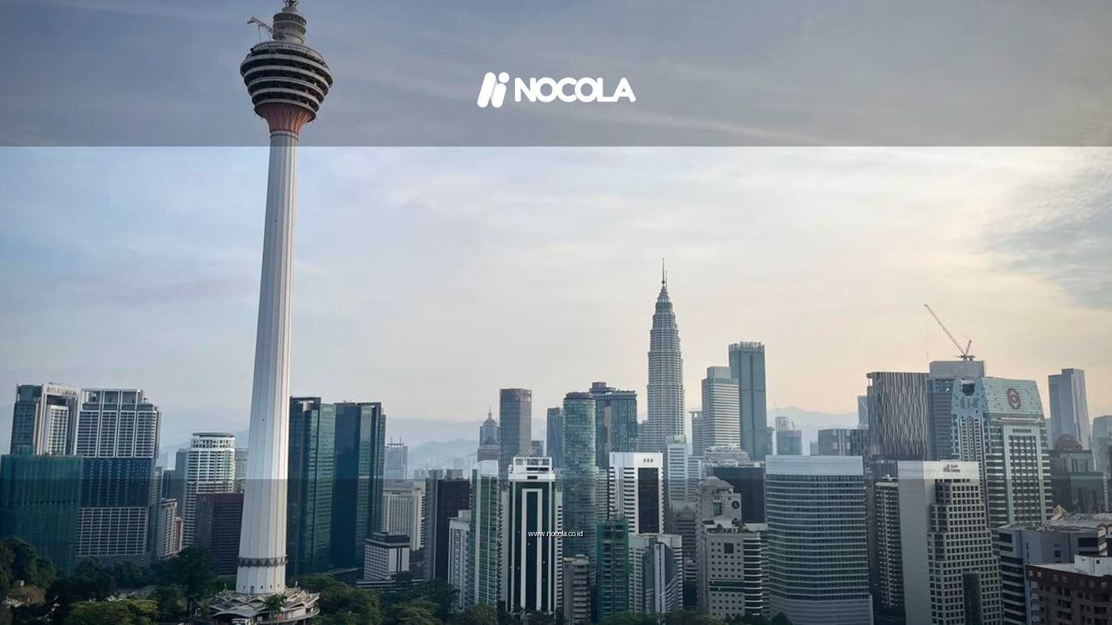 Dramatic view of Kuala Lumpur's skyline featuring the iconic Menara Tower.