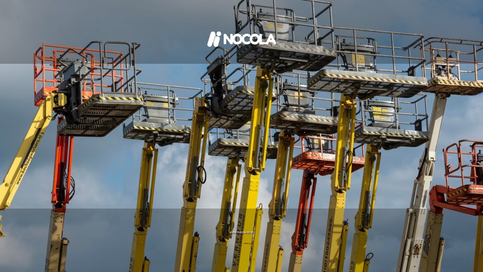 Multiple aerial work platforms with colorful booms reaching skyward against a cloud-dotted backdrop.