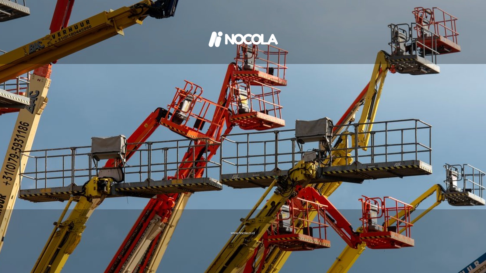 Vibrant boom lifts reaching skyward, showcasing industrial machinery against a clear blue backdrop.