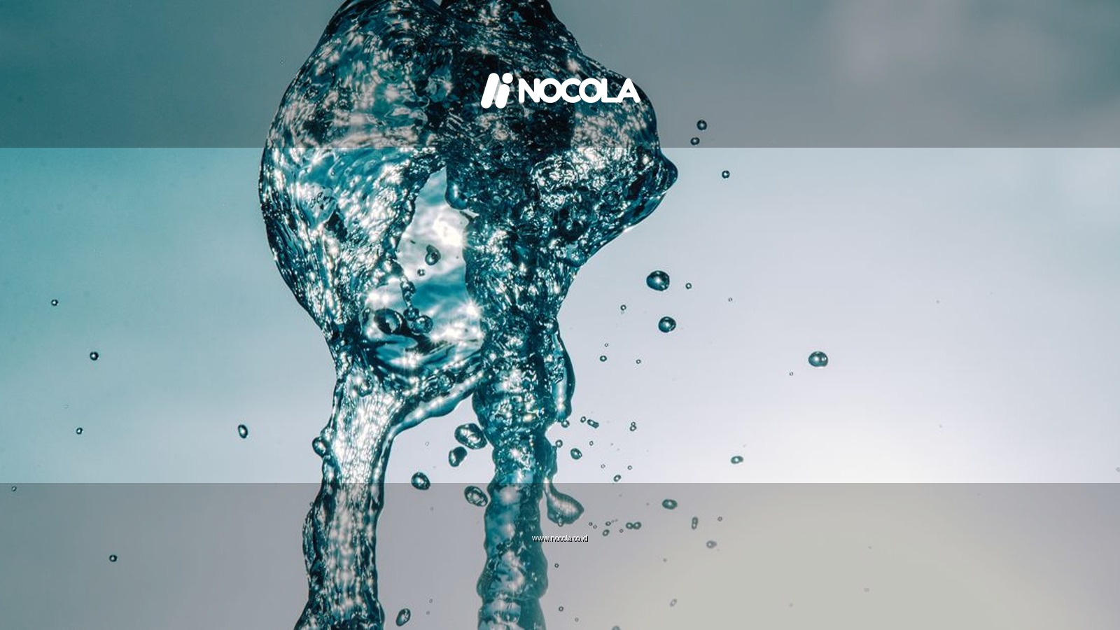Close-up of water splash in mid-air against a bright sky, capturing motion and transparency.