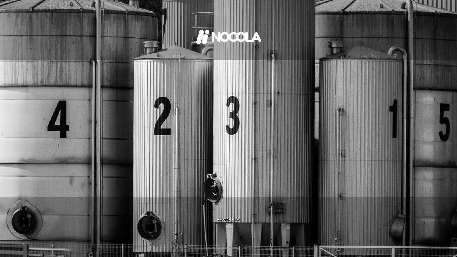 Black and white photo of industrial silos labeled with large numbers 1 to 5.