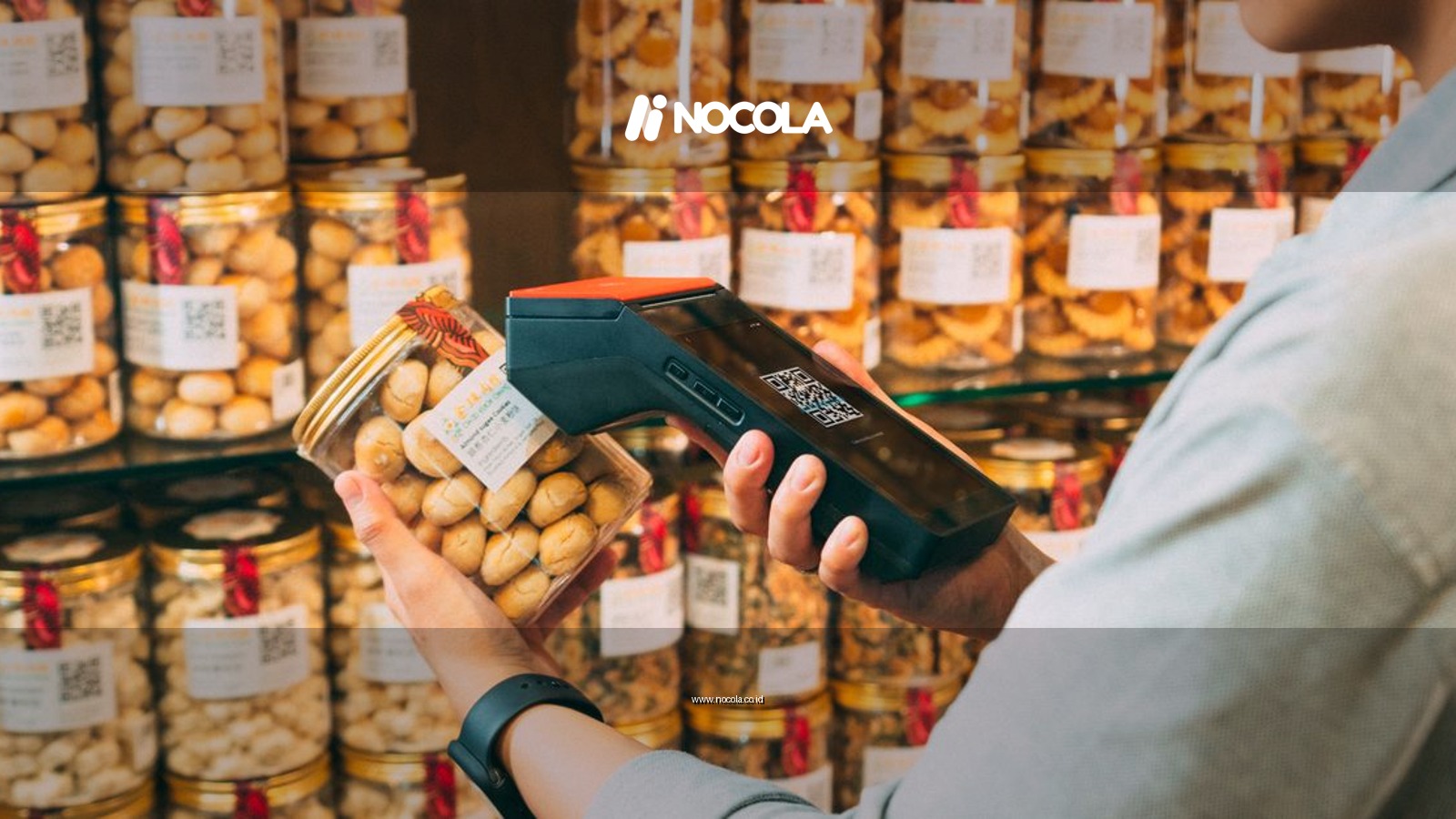 Individual scanning QR codes on jars in a store with a handheld device.