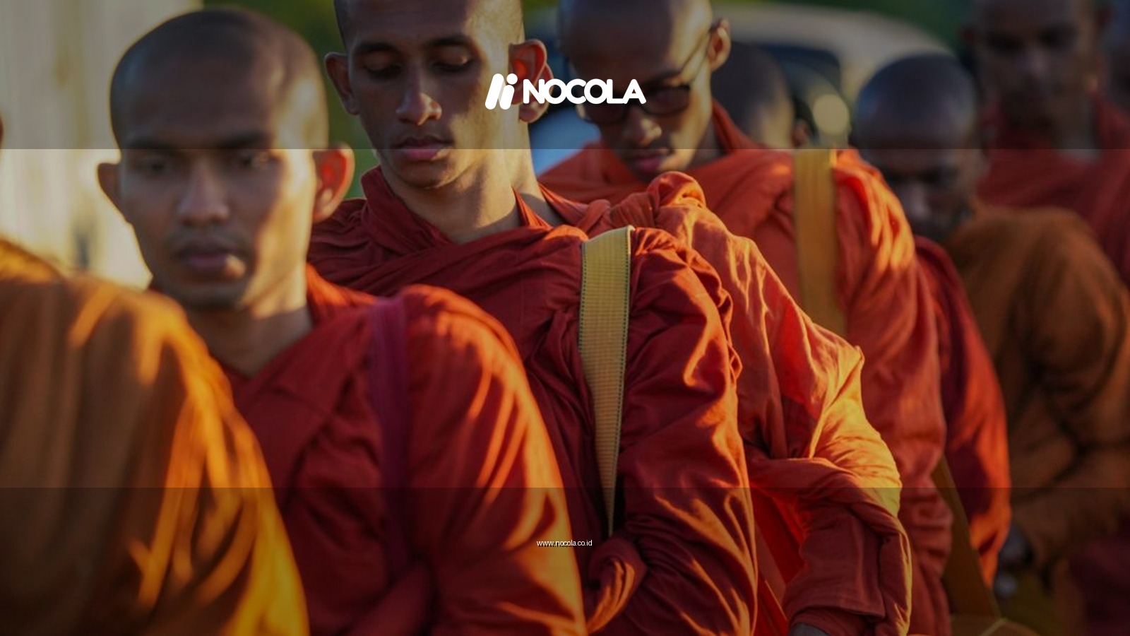Group of Buddhist monks in orange robes on a spiritual pilgrimage in Sri Lanka.