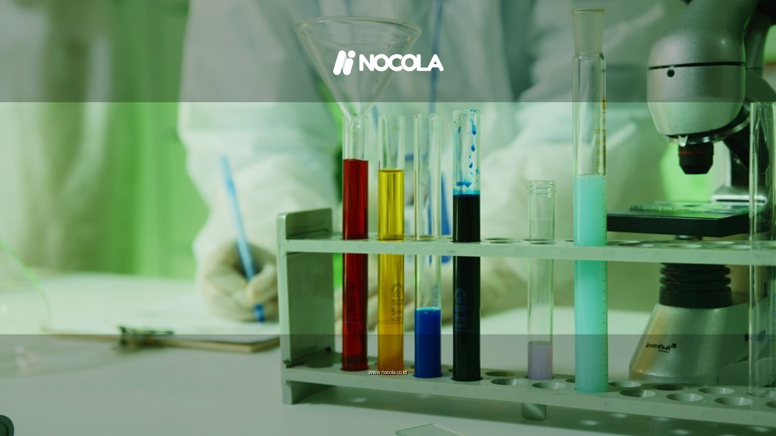 Close-up photo of lab research setup with test tubes and a microscope.