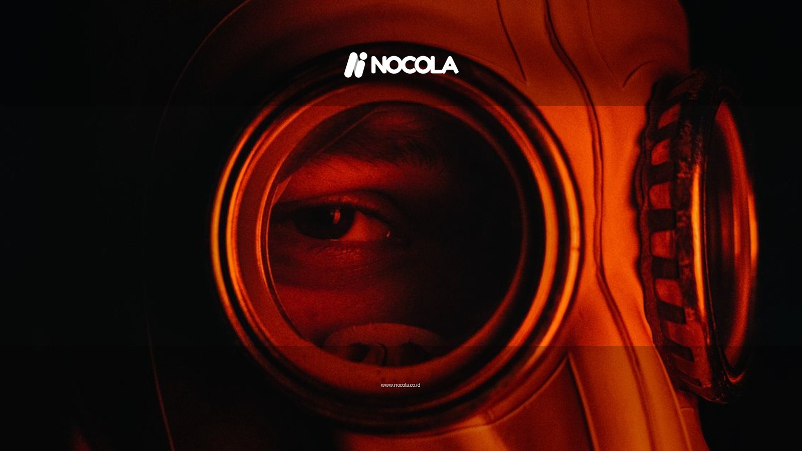 Moody close-up of a person wearing a gas mask with ominous red lighting.
