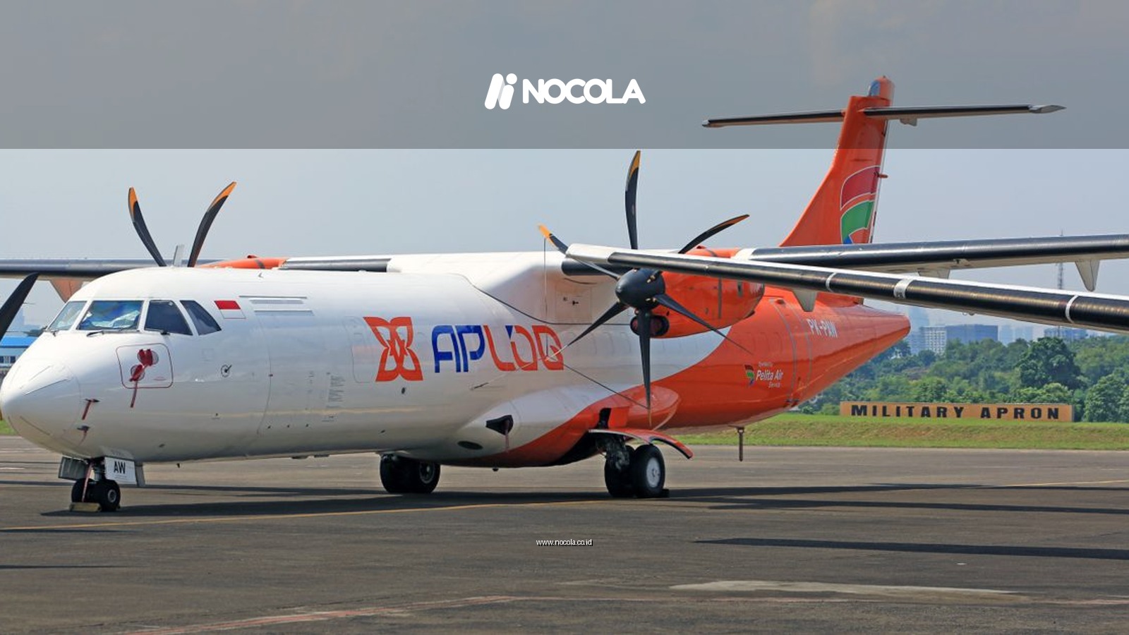 Front view of a commercial propeller aircraft at an Indonesian airport.