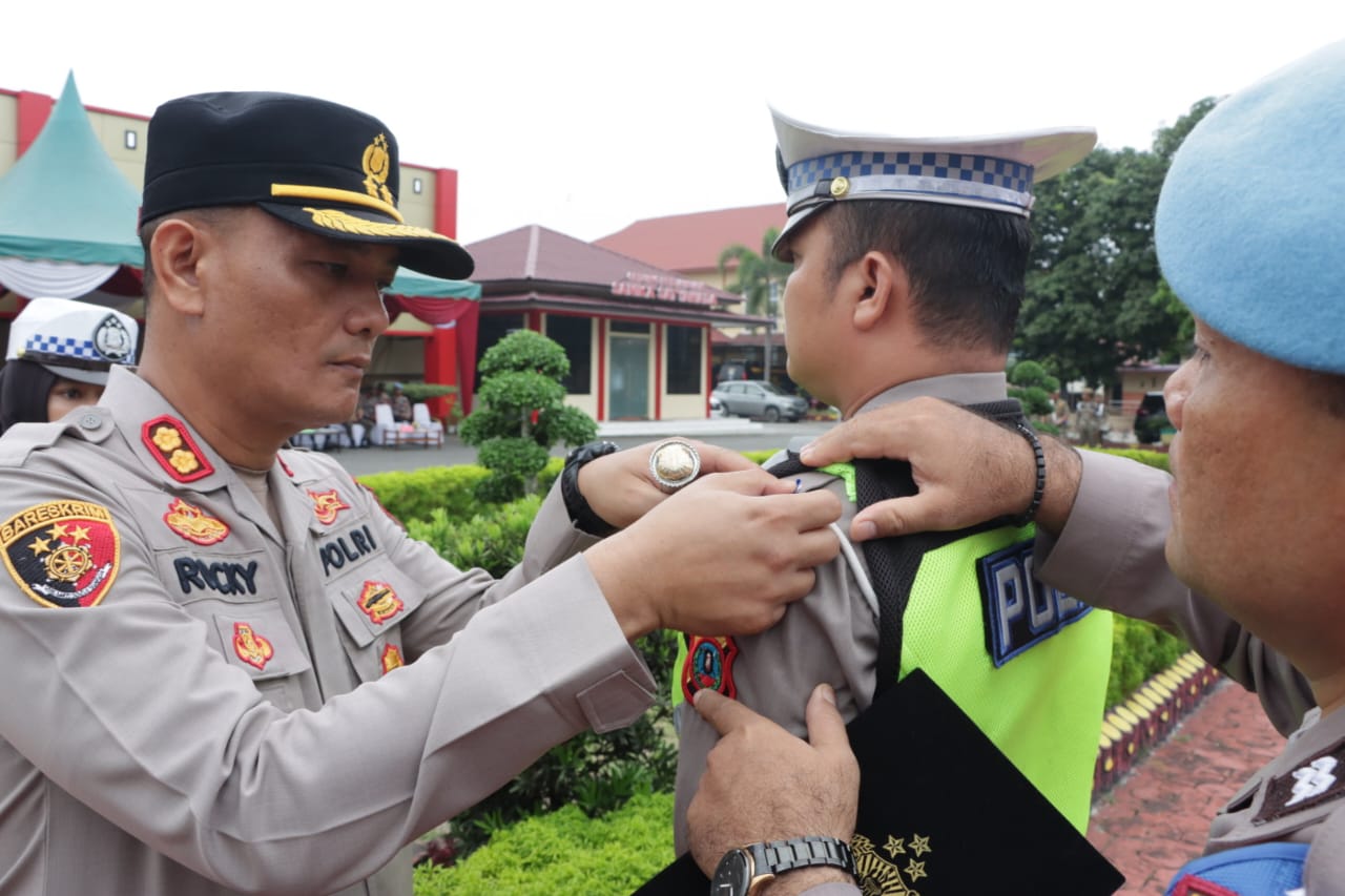 Kapolres Asahan AKBP Rocky H Marpaung saat menyematkan pita pada Tim Polres Asahan di OPS Patu Toba (Ist)