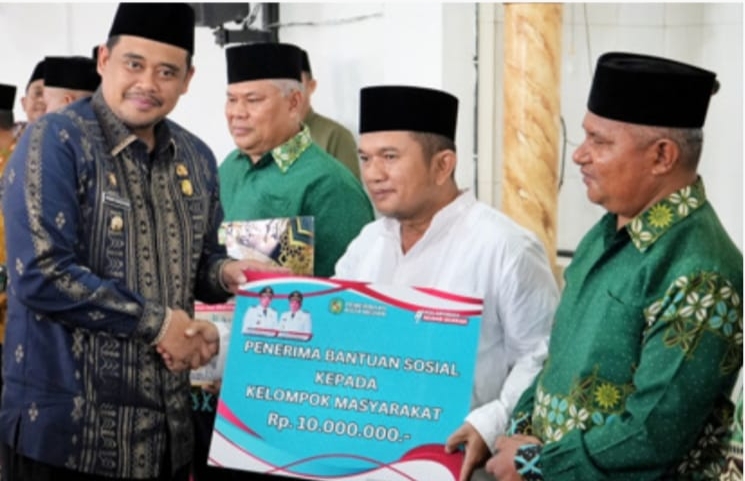 Wali Kota Medan, Bobby Nasution saat memberikan bantu Masjid Taqwa yang diterima Ketua BKM Masjid Taqwa Muhammadiyah, H. Aswan Lubis.
