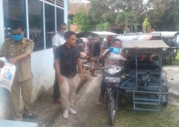 Camat Bandar saat memberikan bantuan kepada para Tukang Tarik Becak Kota Perdagangan