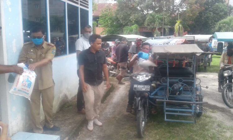 Camat Bandar saat memberikan bantuan kepada para Tukang Tarik Becak Kota Perdagangan