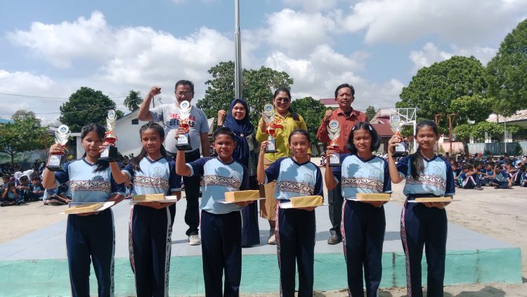 Plt.Kepsek SMP Negeri 1 Tanah Jawa Anggun Nita Sianturi SPd.Pdi.,(mengenakkan kemeja kuning) foto bersama dengan beberapa guru dan siswa berprestasi Tahun Ajaran 2024/2025. (foto:dok SGN)