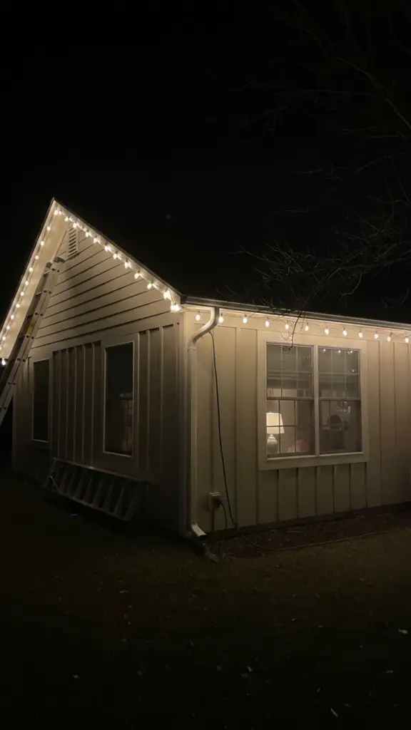 Warm LED C9 strands clipped along a roofline gutter at night