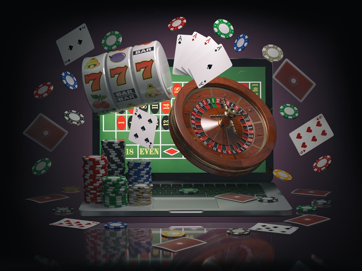 Ilustrasi judi online - Online casino concept. Laptop with roulette, slot machine, casino chips and playing cards isolated on black background. 3d