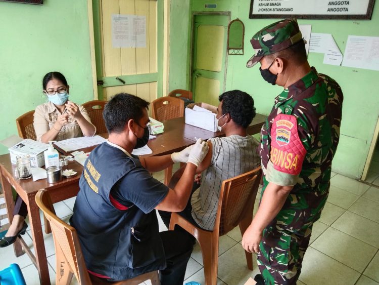 Babinsa Desa Pegagan Julu V - Koramil 01/ Sumbul, Serma Dalan Beluh Sembiring saat memonitor pelaksanaan vaksin dosis 3 (booster), Selasa (22/3).
