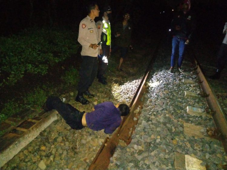 Personil Polsek Rajapolah saat evakuasi mayat tertemer kerata api, Senin malam (25/4).