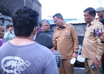 Bupati Toba, Poltak Sitorus bersama staf jajaran Pemkab Toba saat tinjau 3 rumah yang terbakar di Laguboti, Senin (27/6).
