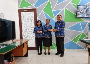 Kadis Dukcapil Kabupaten Dairi, Deddy Situmorang SE, M.Si saat menyerahkan 129 keping Kartu Identitas Anak (KIA) yang diterima Kepala Sekolah (Kasek) SD Negeri 034802 Lae Markelang, Elsariana Sihombing S.Pd, Kamis (10/11)