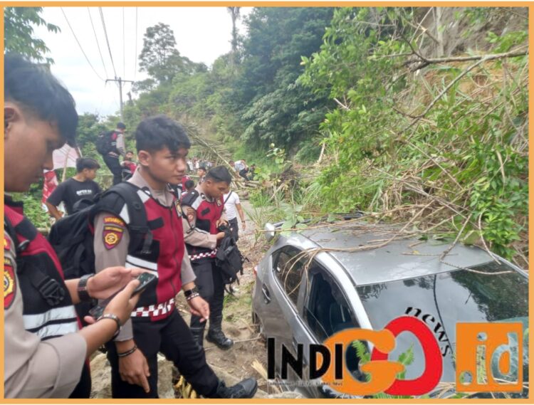 Personel Polres Taput saaat evakuasi mobil honda brio yang tertimpa longsor, Rabu (27/12).