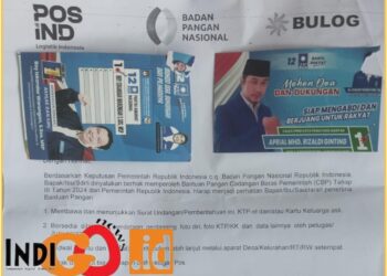 Surat undangan penerima bantuan pangan berupa cadangan beras negara yang di tempel hekter dengan kartu nama 2 Caleg PAN, Sabtu (3/2).