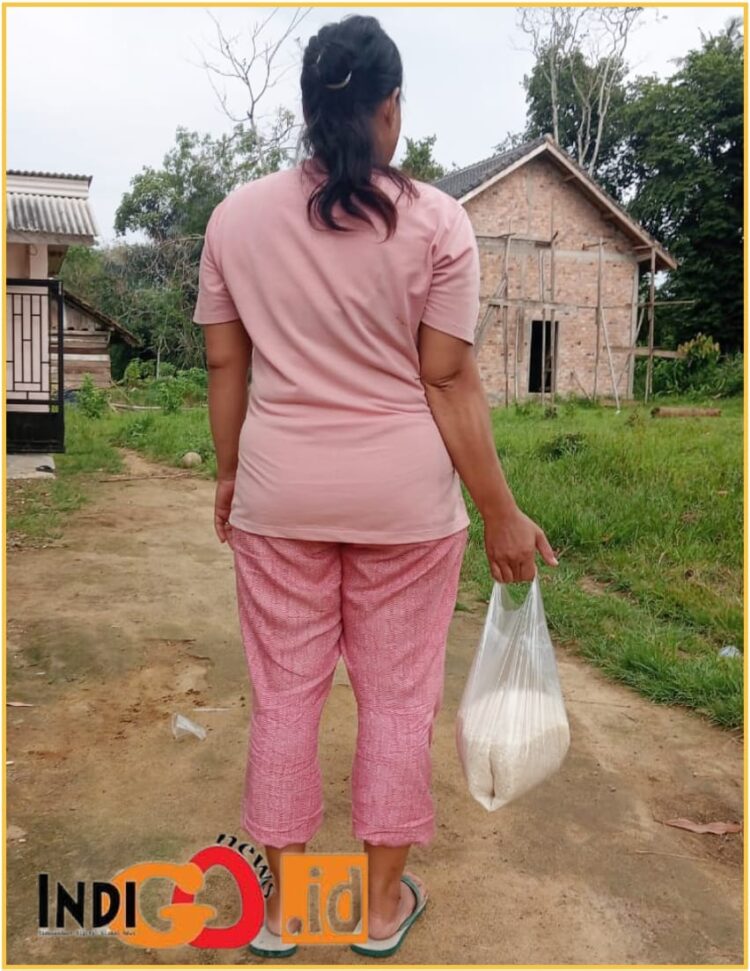 Seorang IRT saat baru membeli beras, Rabu (21/2).