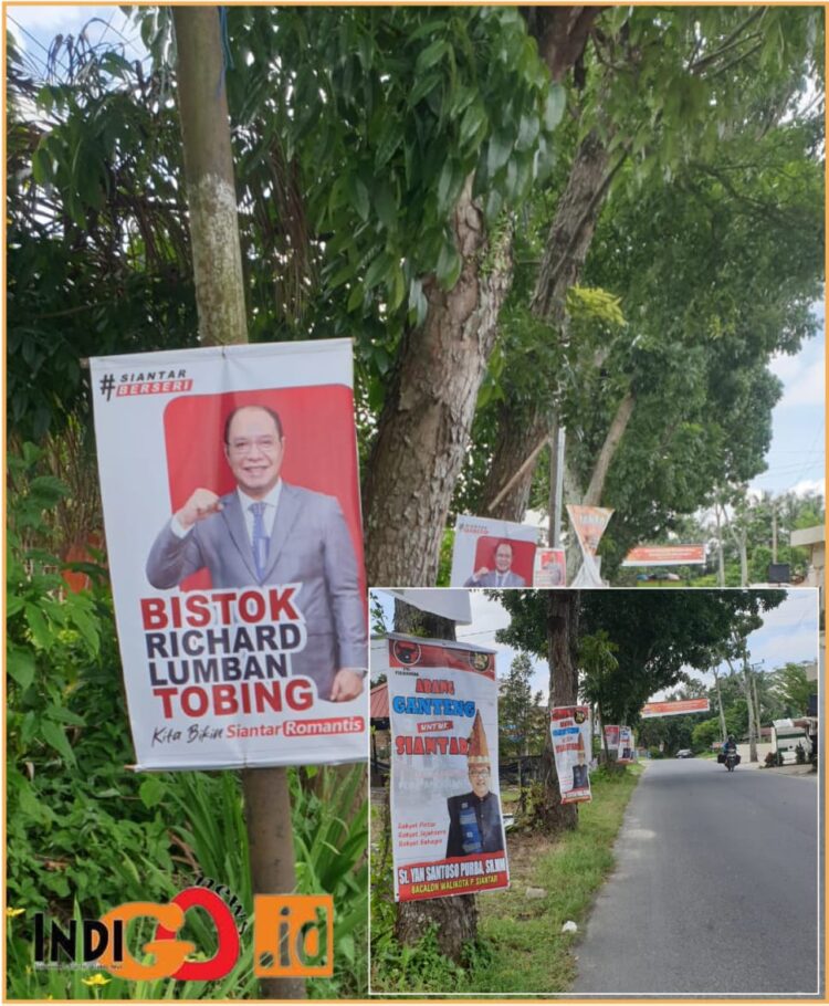 Poster Bistok dan Yan Santoso dijalan Pdt. J Wismar Saragih yang dipaku dipepohonan, Rabu (10/7).