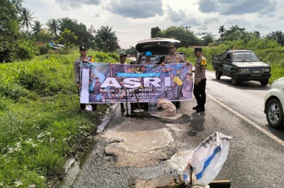 Polsek Lembak Tambal Jalan Lintas Palembang -Prabumulih Yang Berlubang
