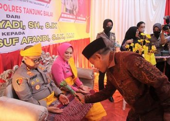 Plt. Wali Kota Tanjungbalai H. Waris Tholib memakaikan pakaian adat Melayu sekaligus pemberian tepung tawar kepada Kapolres Tanjungbalai yang baru, AKBP Ahmad Yusuf Afandi beserta istri