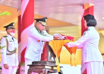 Gubernur Sumut Edy Rahmayadi memberikan bendera merah putih kepada petugas Paskibraka pada upacara pengibaran bendera merah putih dalam rangka HUT Kemerdekaan RI ke-77. (Foto Ist)